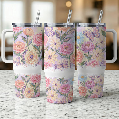Floral and butterfly pattern tumbler with handle and straw.
