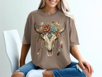 Brown t-shirt featuring a floral bull skull graphic with feathers.