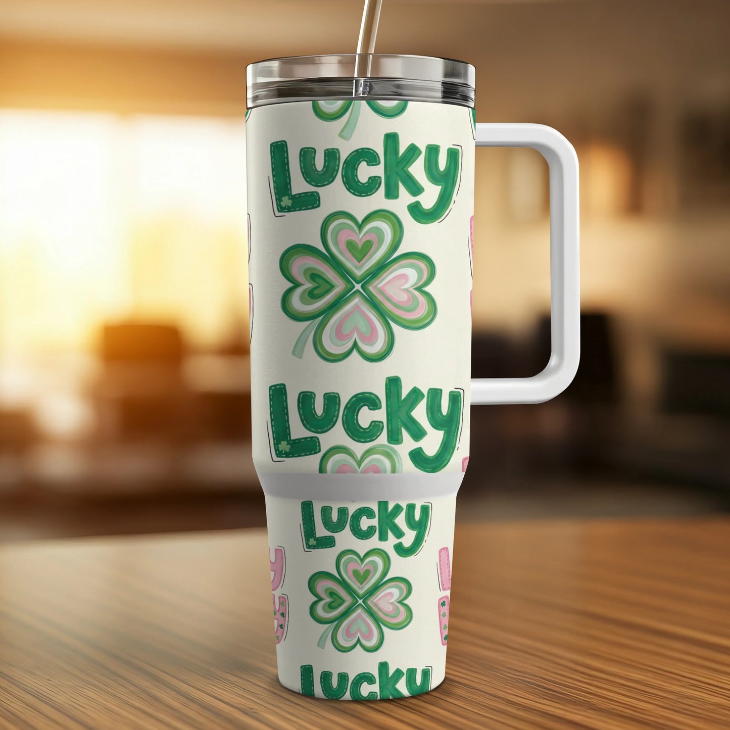 Green and pink lucky shamrock patterned insulated tumbler with handle.