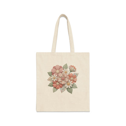 Canvas tote bag with a floral pattern in muted pinks and greens.