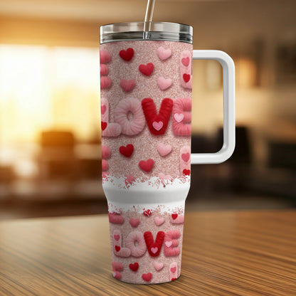 Pink tumbler with "LOVE" repeated in fuzzy, glittery letters.