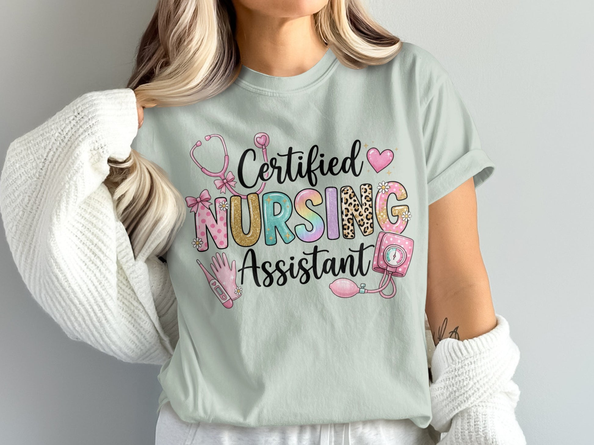 Certified Nursing Assistant text with stethoscope, heart, and medical icons on a light t-shirt.