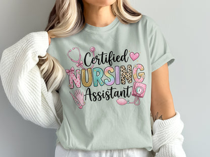 Certified Nursing Assistant text with stethoscope, heart, and medical icons on a light t-shirt.