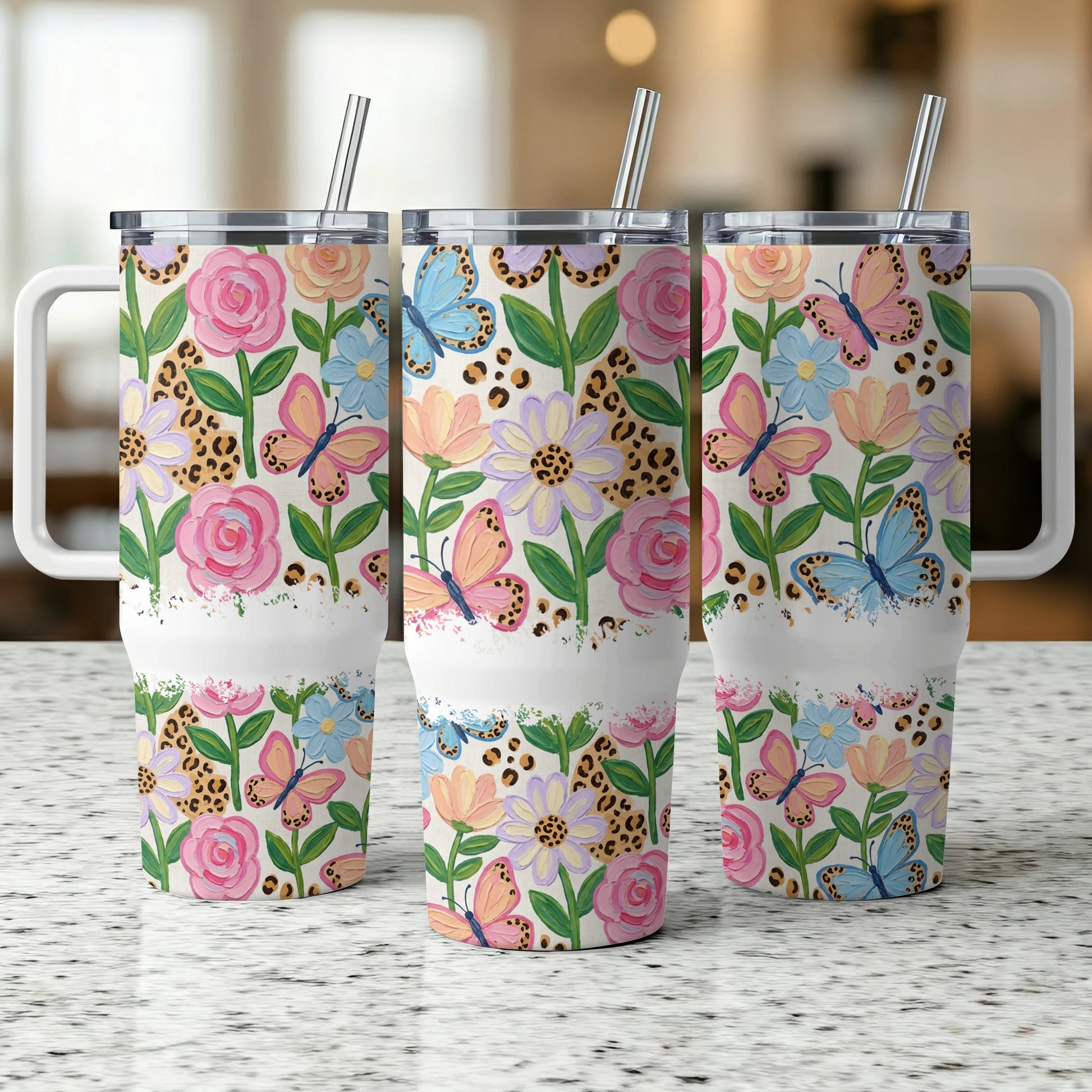 Three floral and butterfly patterned tumblers with leopard print accents.