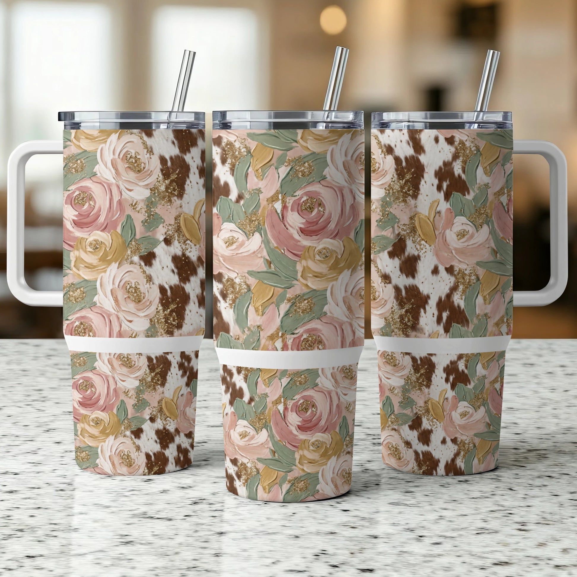 Three tumblers with floral and cowhide patterns side by side.