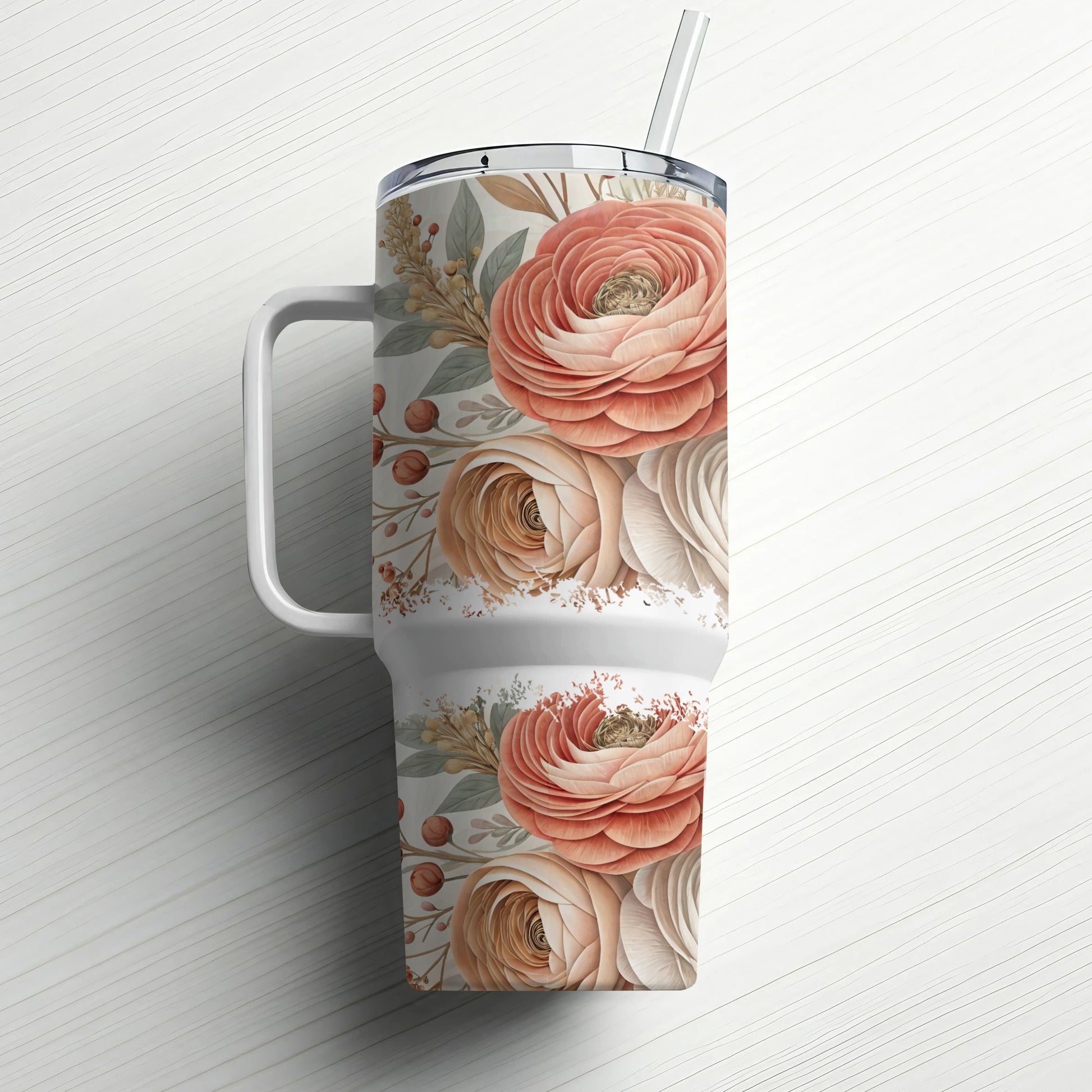 Floral patterned tumbler with handle and straw.