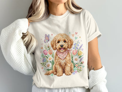 Cream t-shirt featuring a watercolor doodle dog with a pink bandana among flowers.