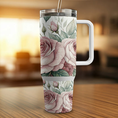 Pink roses on a white travel tumbler with a straw and handle.