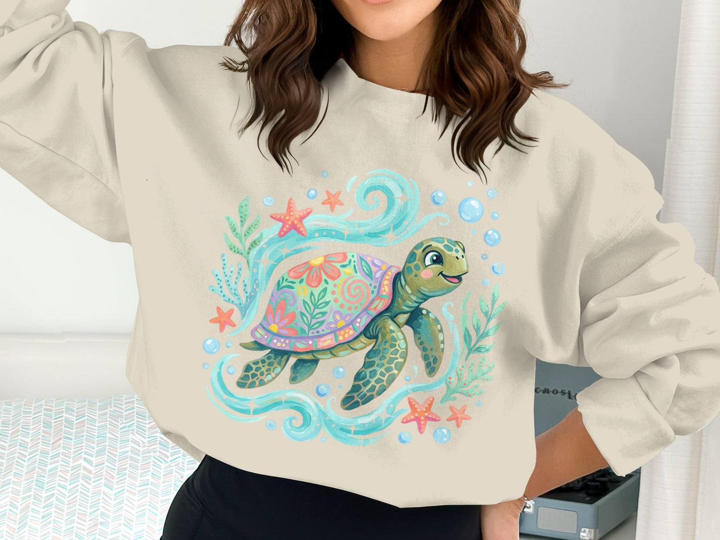 Sweatshirt with a cartoon sea turtle surrounded by starfish, coral, and bubbles.