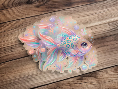 Pastel watercolor fish sticker with shells and bubbles on wood background.
