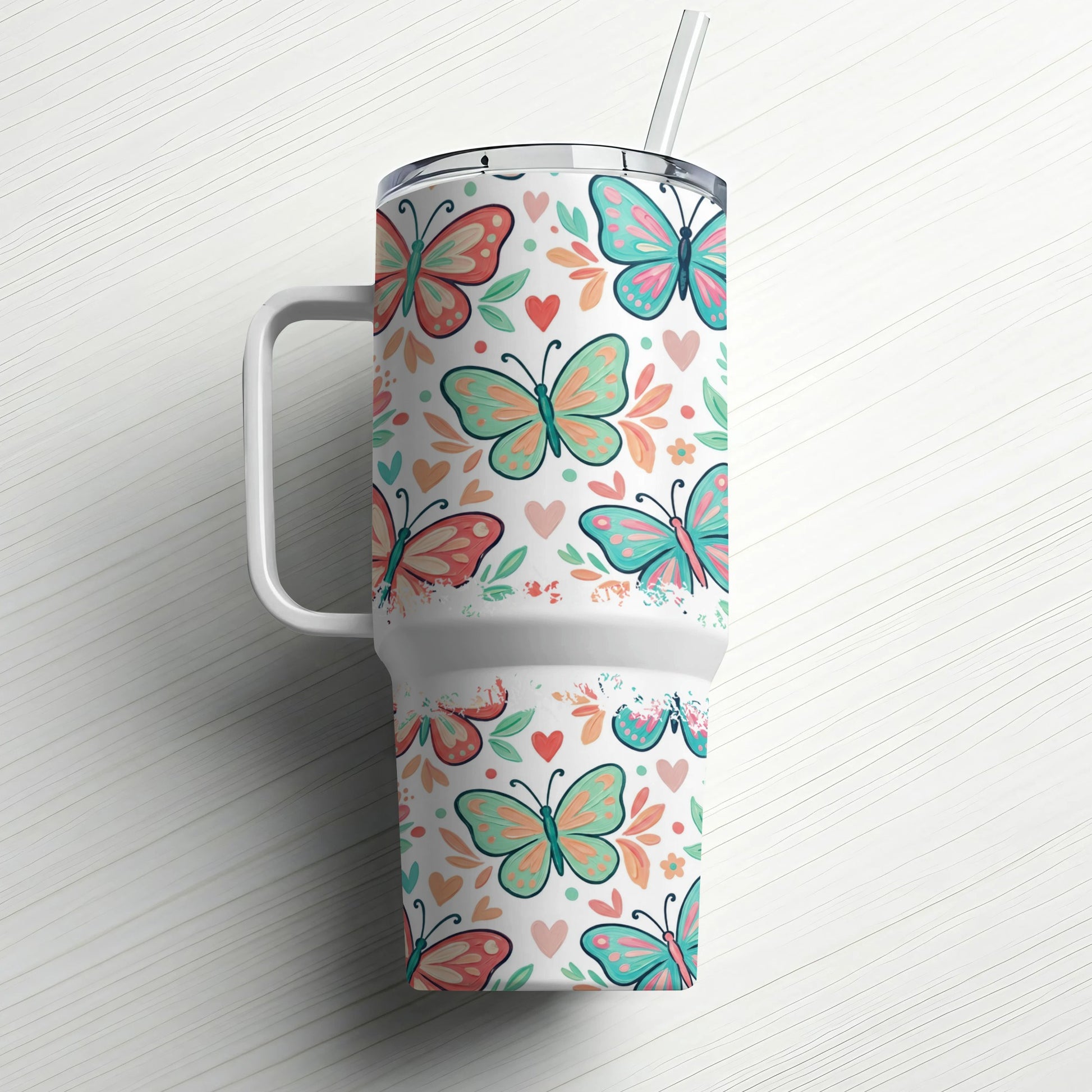White tumbler with colorful butterfly and heart pattern and straw.