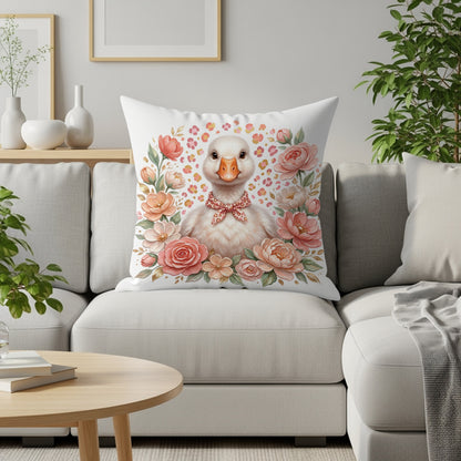 White goose wearing a pink bow tie surrounded by peach and coral roses.