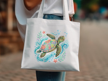 White tote bag with a colorful sea turtle illustration and bubbles.