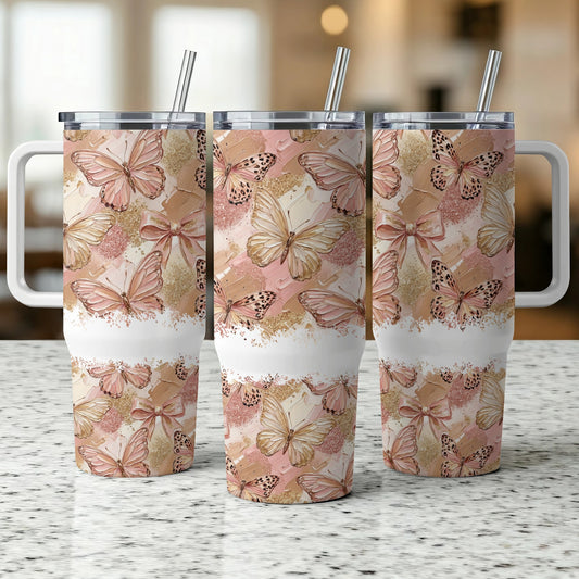 Three stainless steel tumblers with butterfly and textured paint designs.