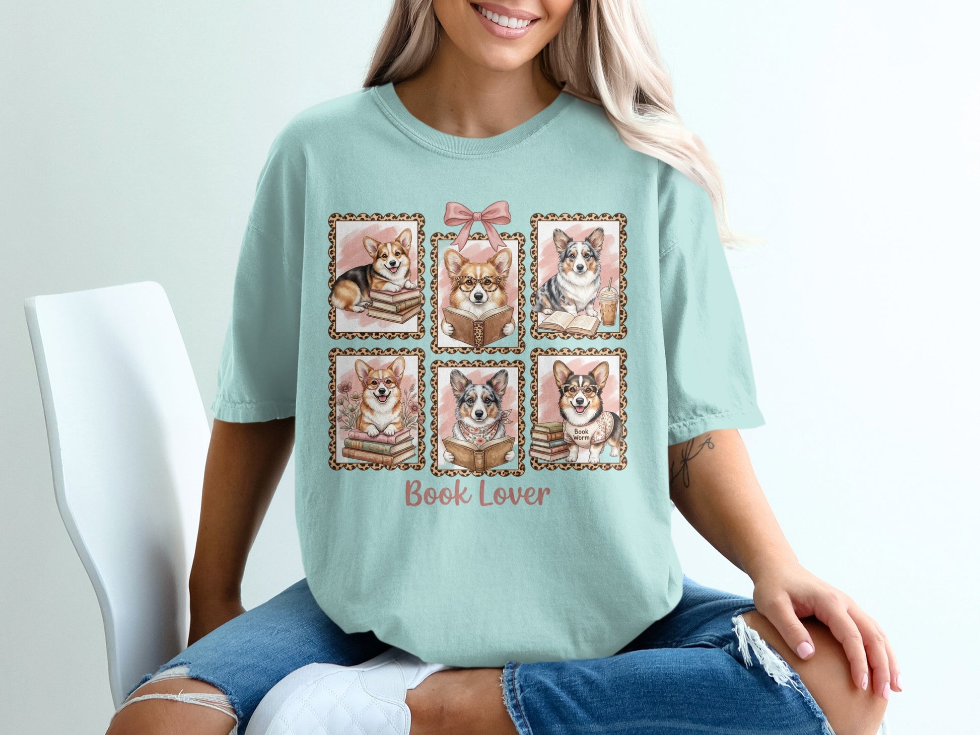 Six framed corgi illustrations, reading books, on a light teal t-shirt.
