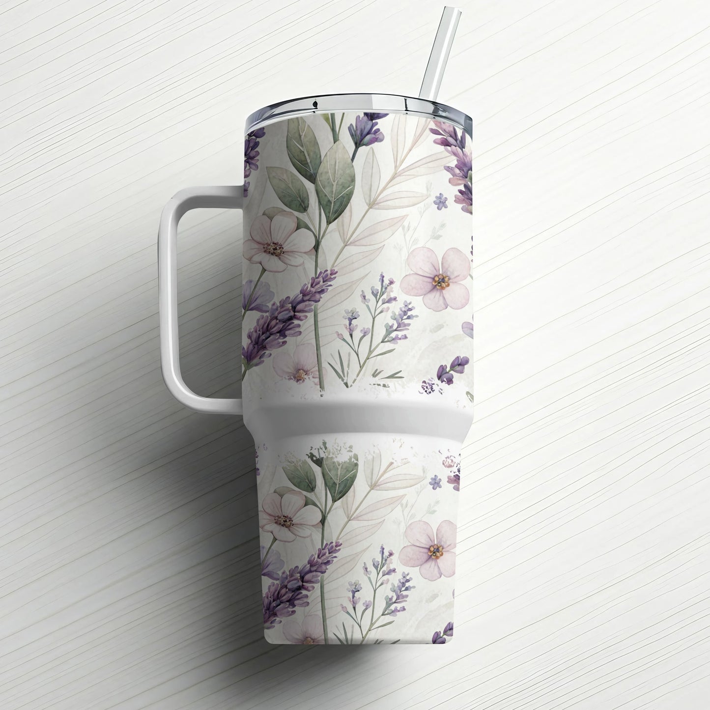 White tumbler with handle and straw, decorated with a floral and lavender pattern.