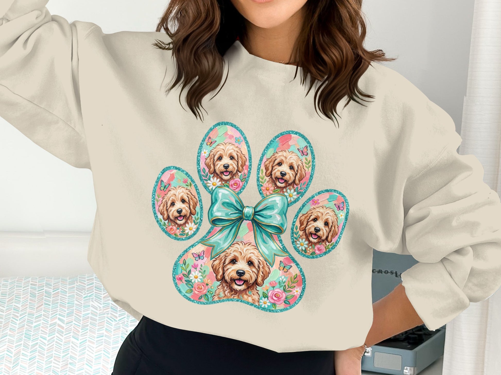 Cream sweatshirt with a paw print filled with dog faces and floral accents.