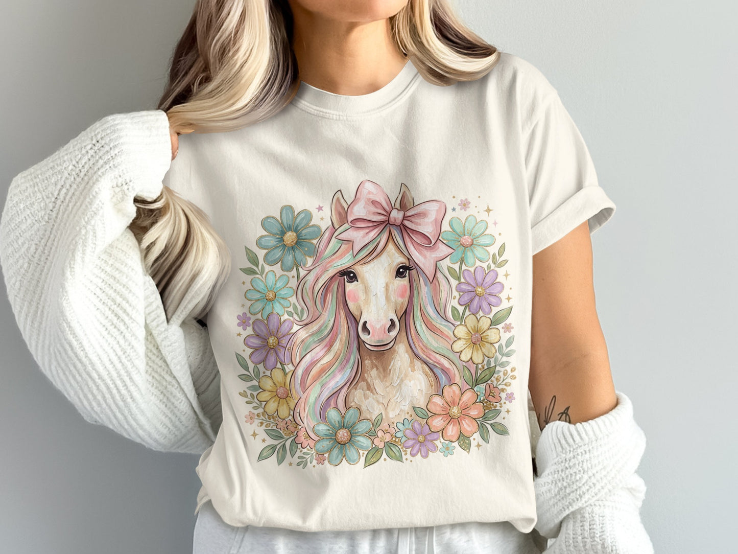 Unicorn with pastel mane and flowers, wearing pink bow.