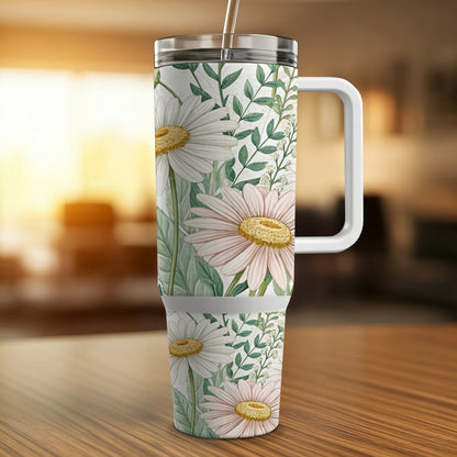 White tumbler with daisies and green leaves pattern, white handle.
