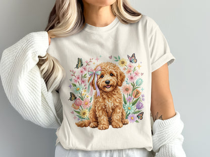 Fluffy golden doodle puppy wearing a pink bow, surrounded by colorful flowers and butterflies.