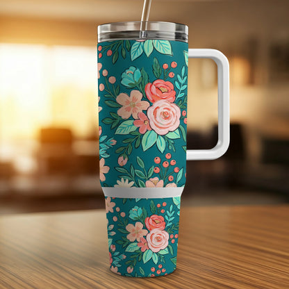 Teal tumbler with floral pattern and white handle.