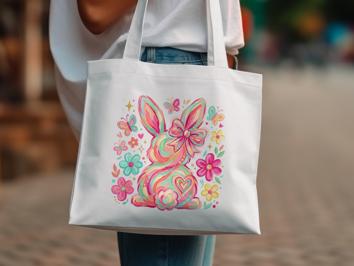 White tote bag with colorful Easter bunny and floral design.