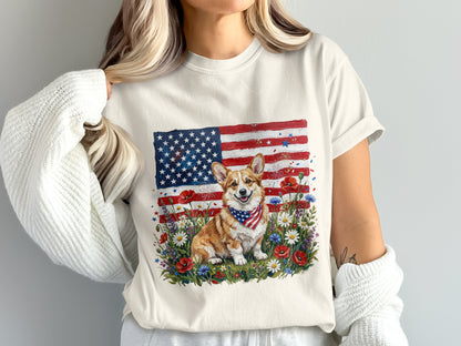 Corgi wearing a bandana sits in front of an American flag and wildflowers.