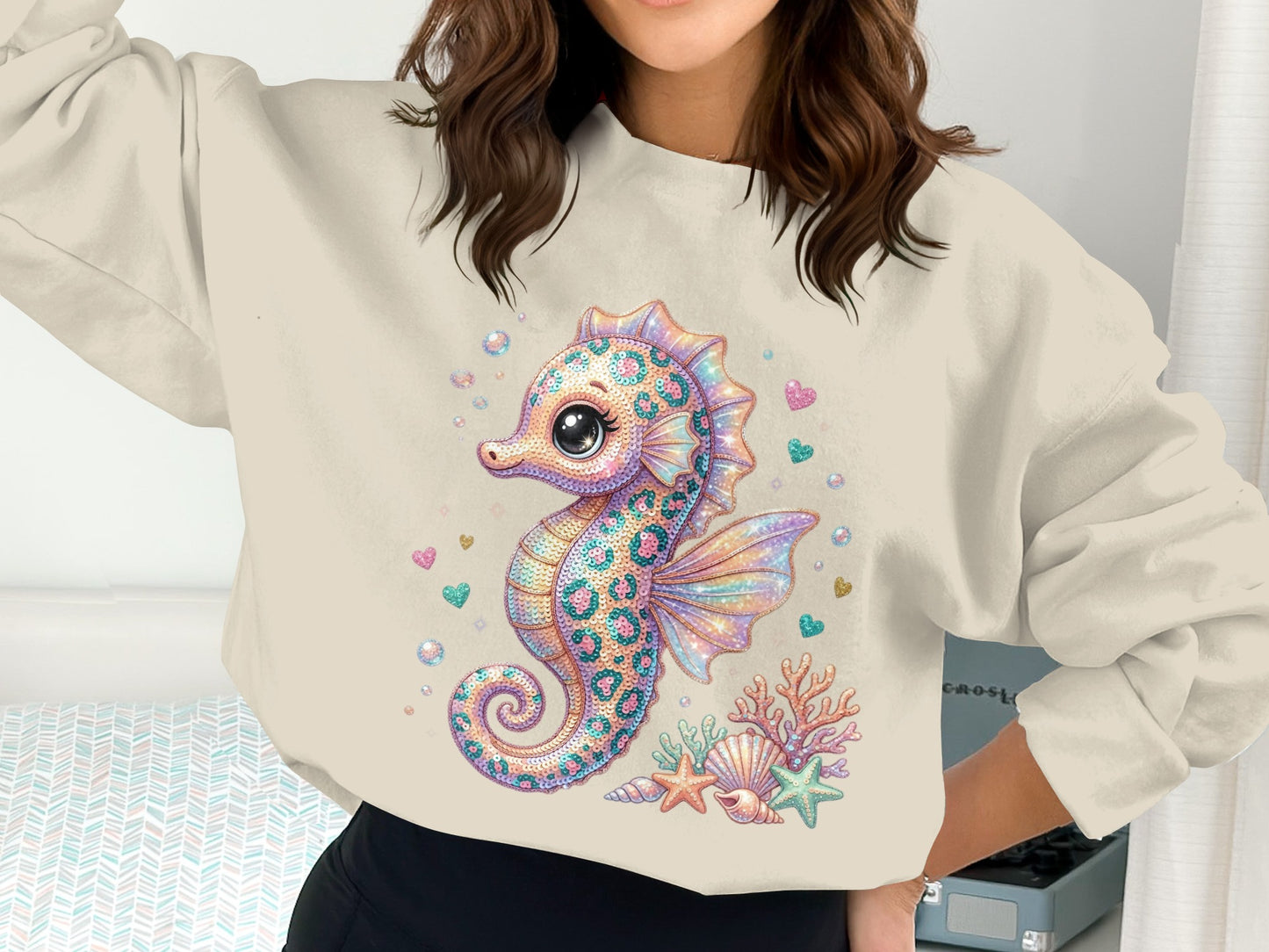 Seahorse graphic sweatshirt with seashells and hearts.