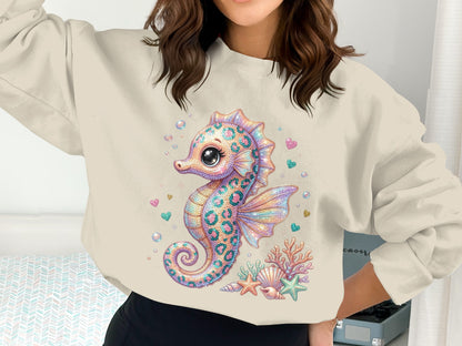 Seahorse graphic sweatshirt with seashells and hearts.