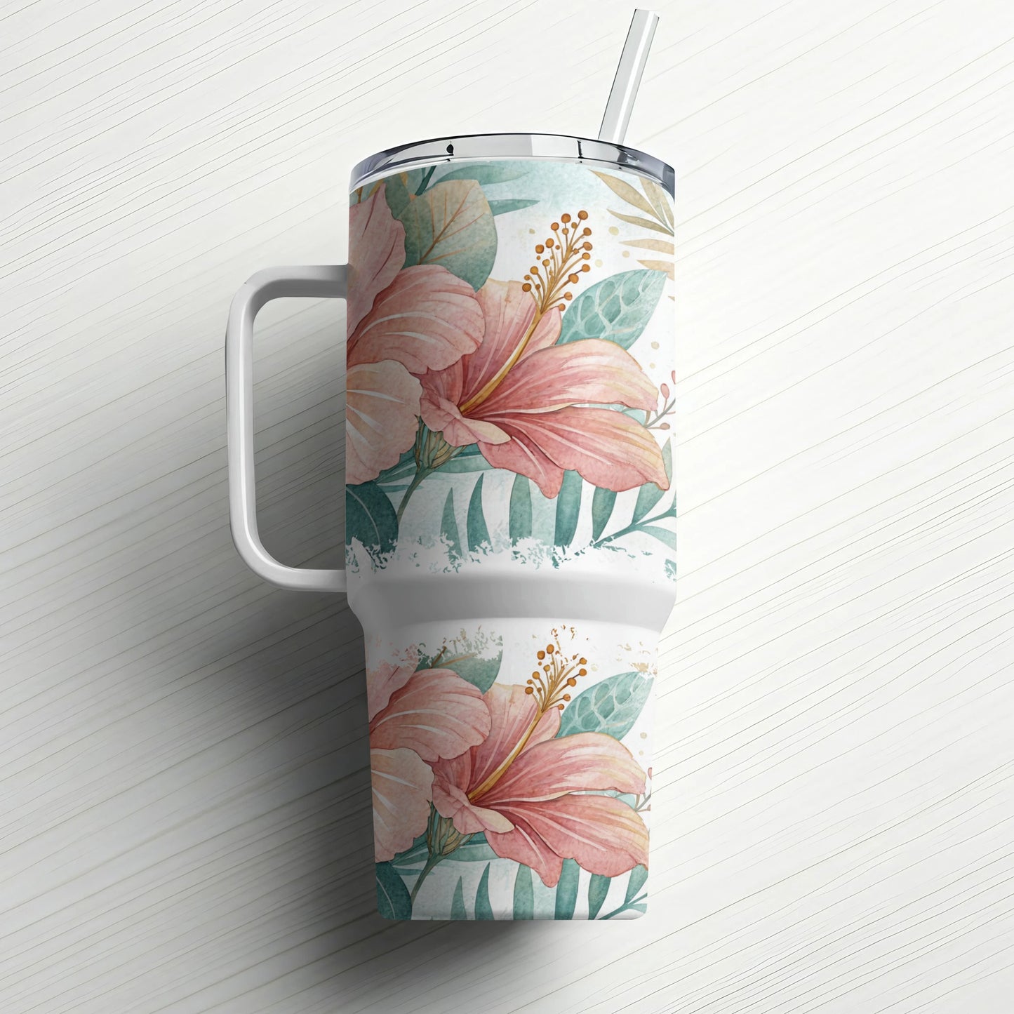 Floral tumbler with handle and straw, featuring pink hibiscus flowers and green leaves.