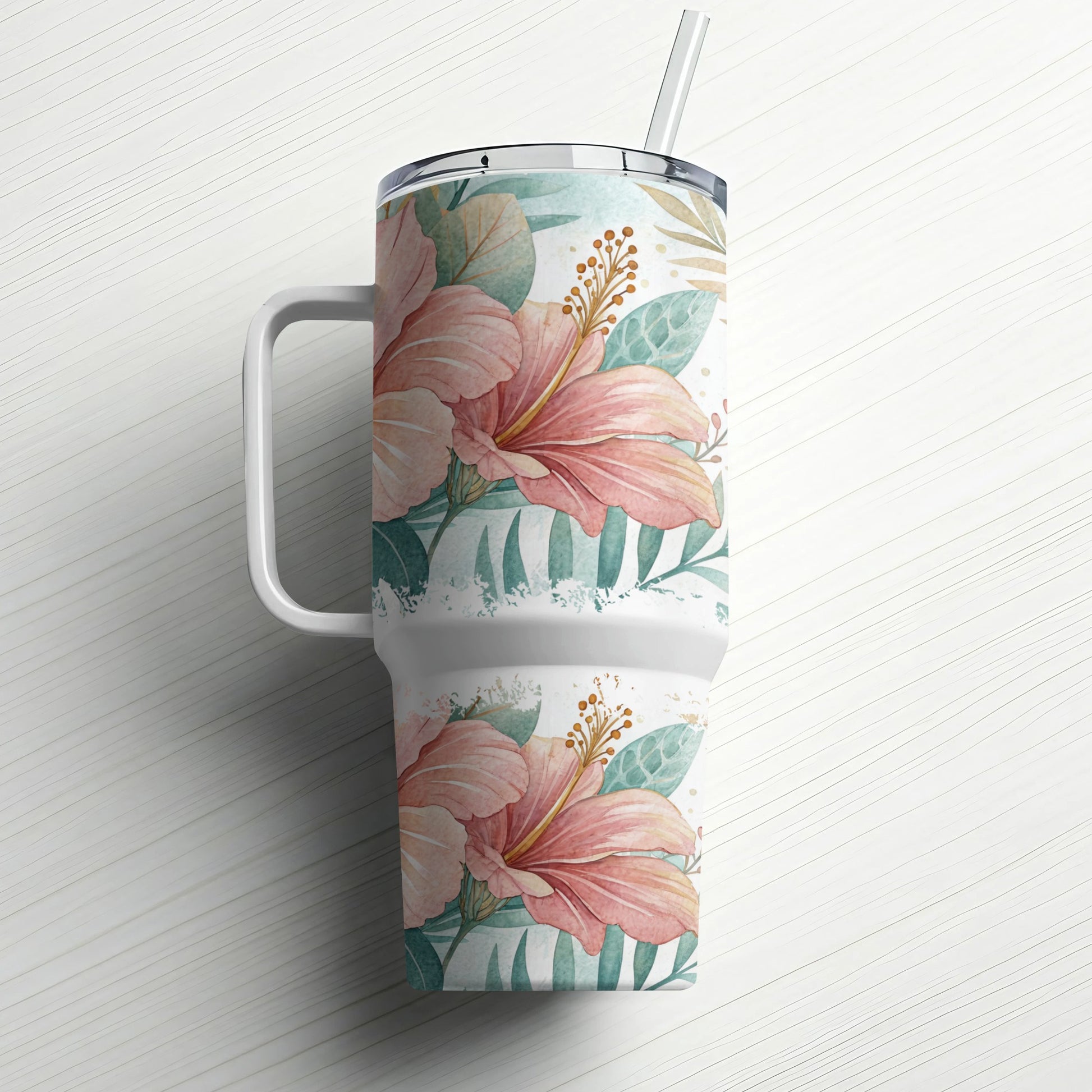 Floral tumbler with handle and straw, featuring pink hibiscus flowers and green leaves.