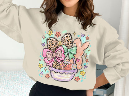 Easter basket with eggs, bows, and bunny, printed on a light-colored sweatshirt.