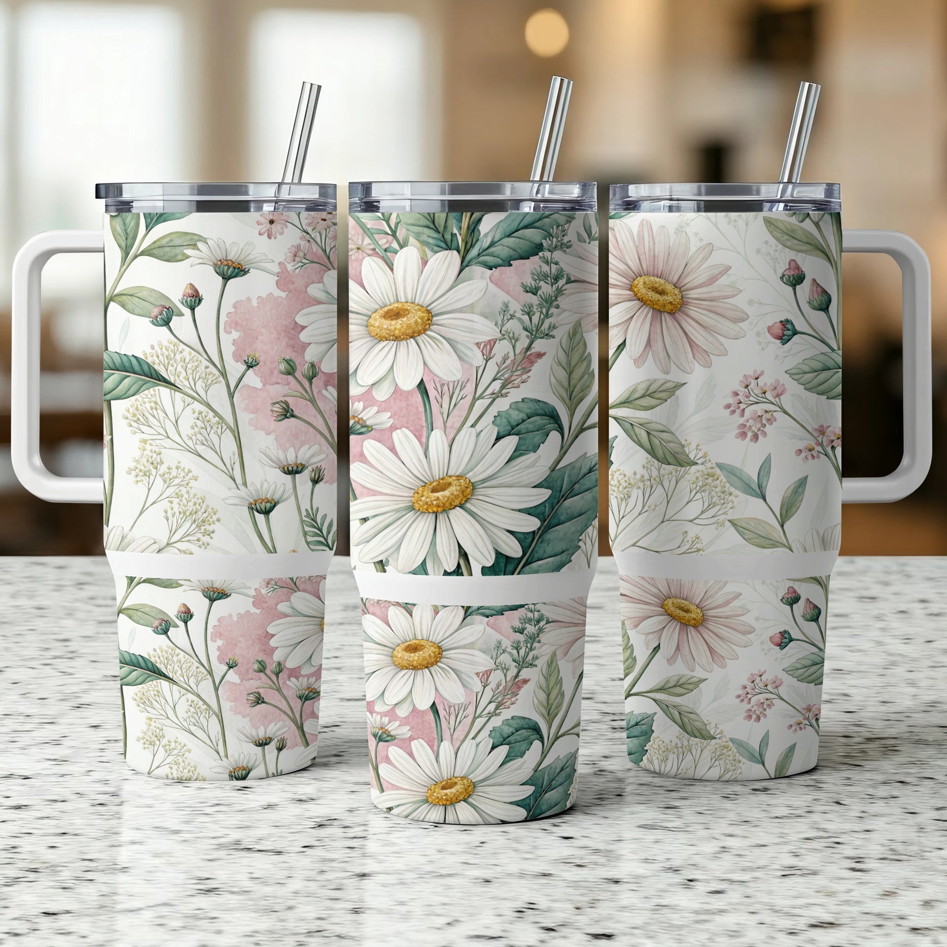 Three insulated tumblers with a floral daisy and pink watercolor design.