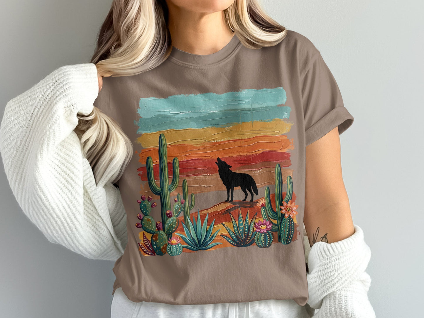 T-shirt with howling wolf, cacti, and desert sunset graphic.