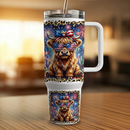 Highland cow wearing sunglasses with American flags and fireworks on a patriotic tumbler.