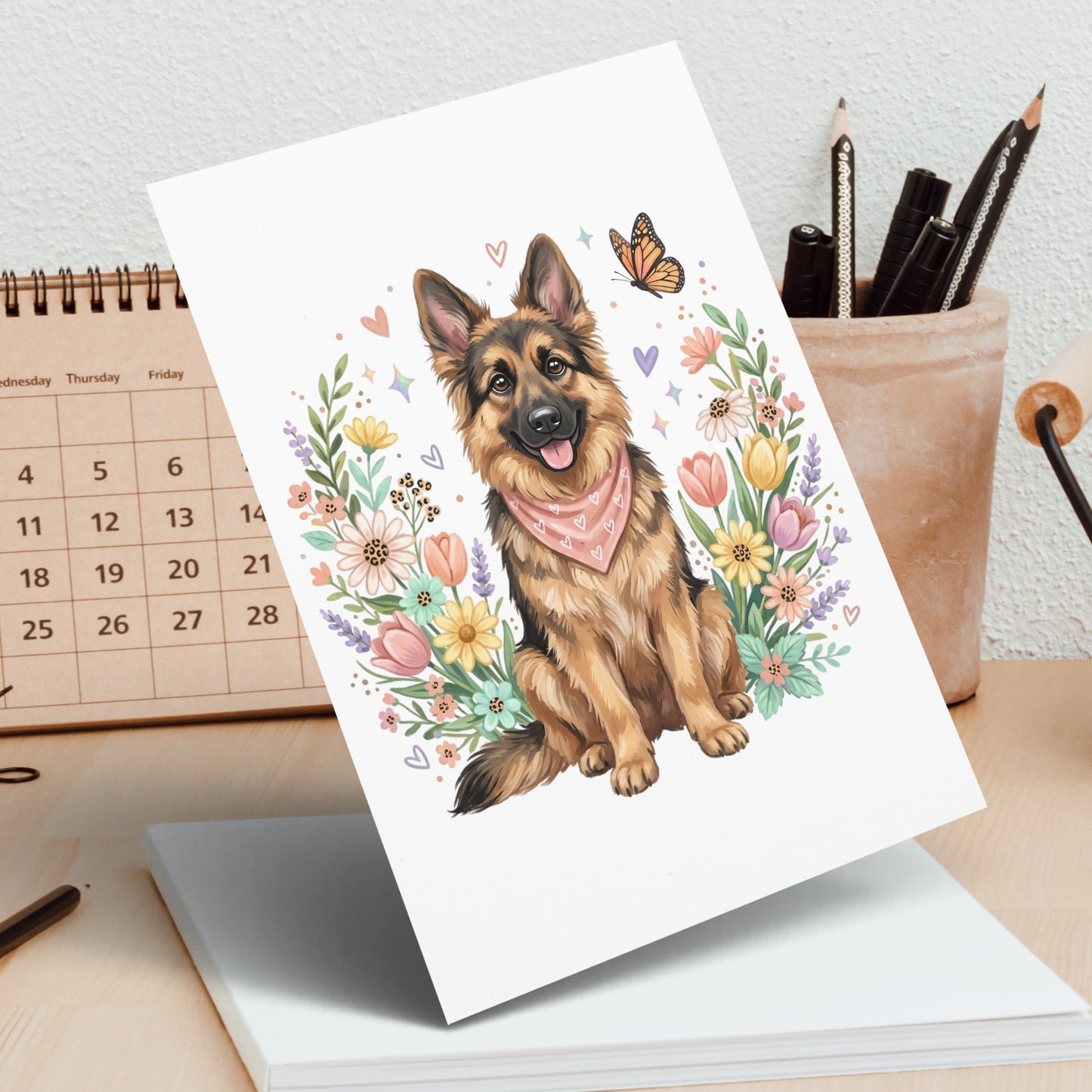 German Shepherd dog wearing a bandana, surrounded by floral and butterfly border.