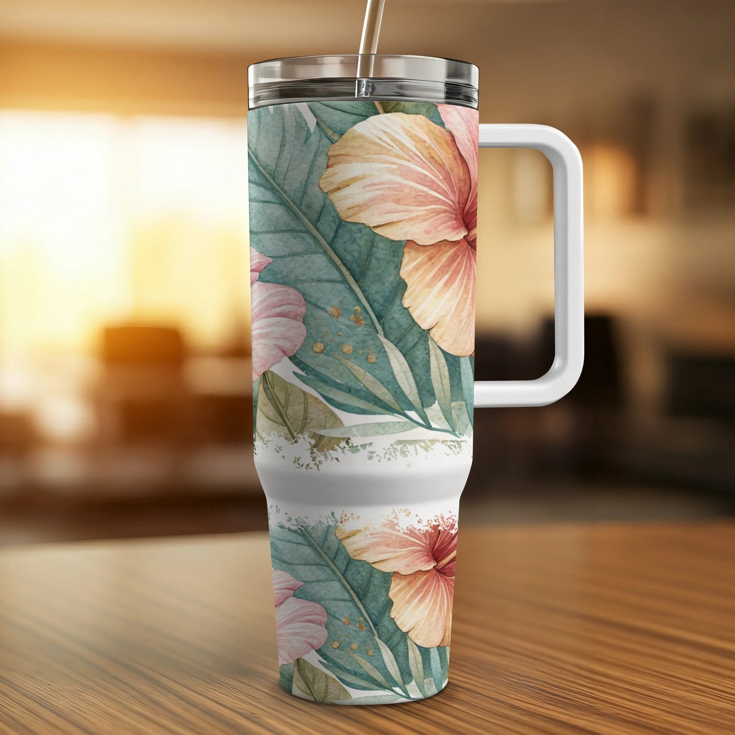 Floral tropical tumbler with handle and straw on a wooden surface.