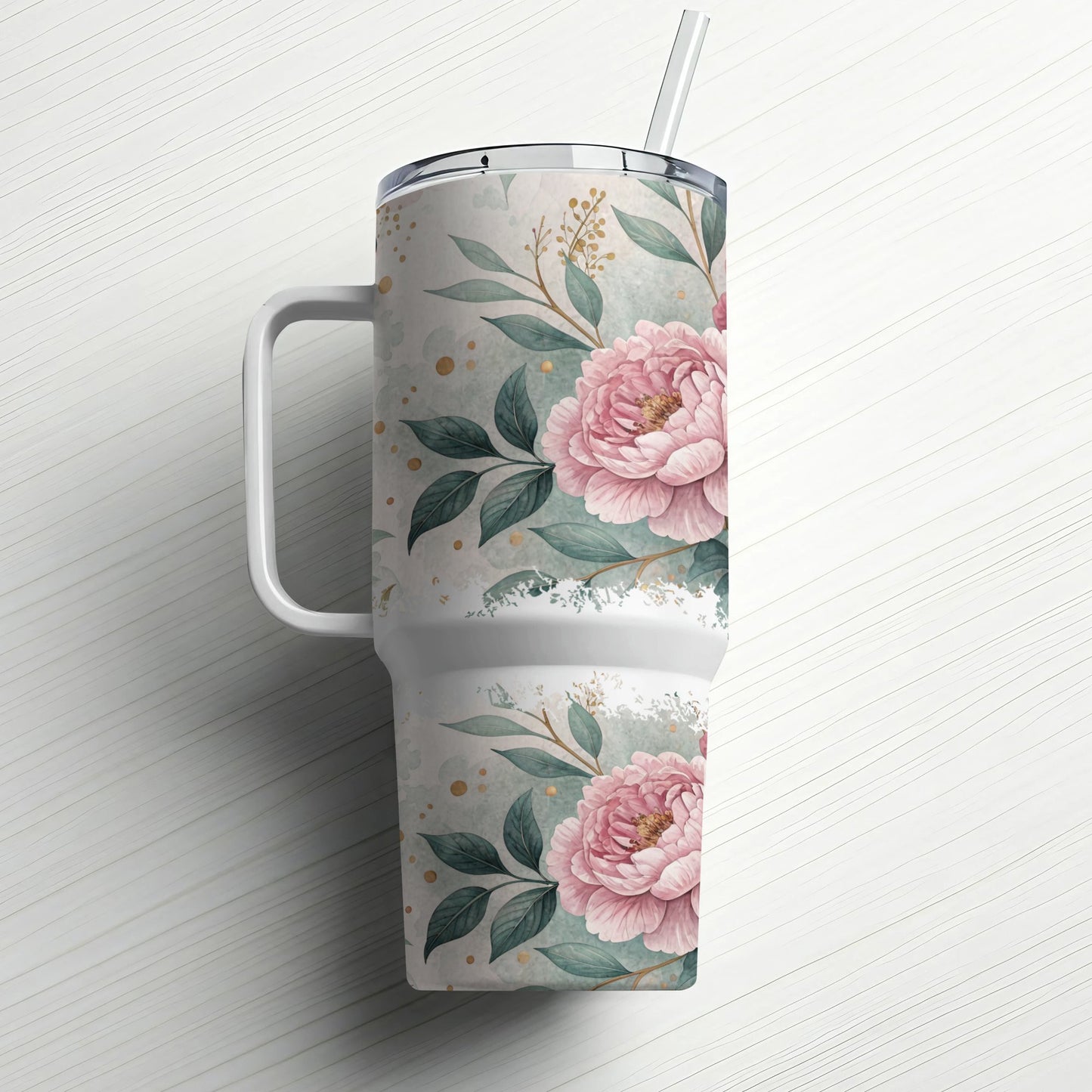 White tumbler with pink floral design and straw on white background.