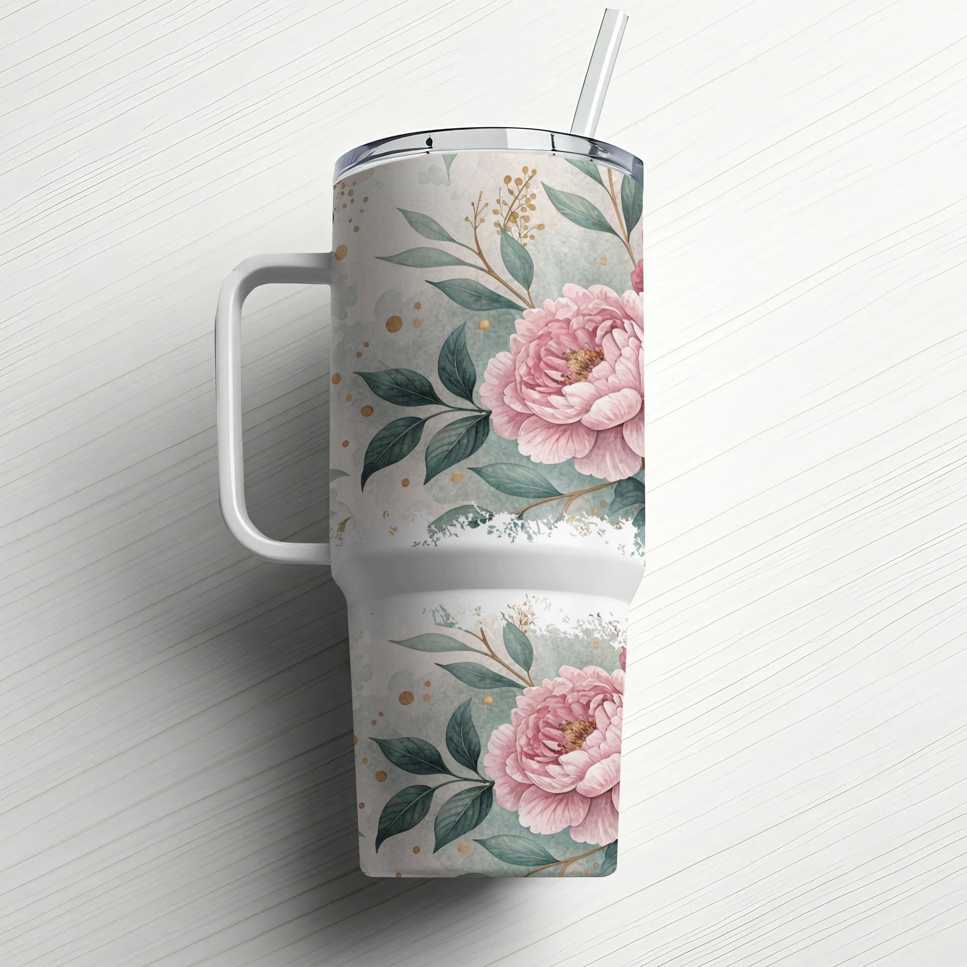White tumbler with pink floral design and straw on white background.