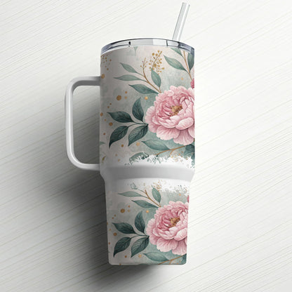 White tumbler with pink floral design and straw on white background.