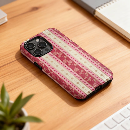 Striped phone case with floral accents on a wooden desk.