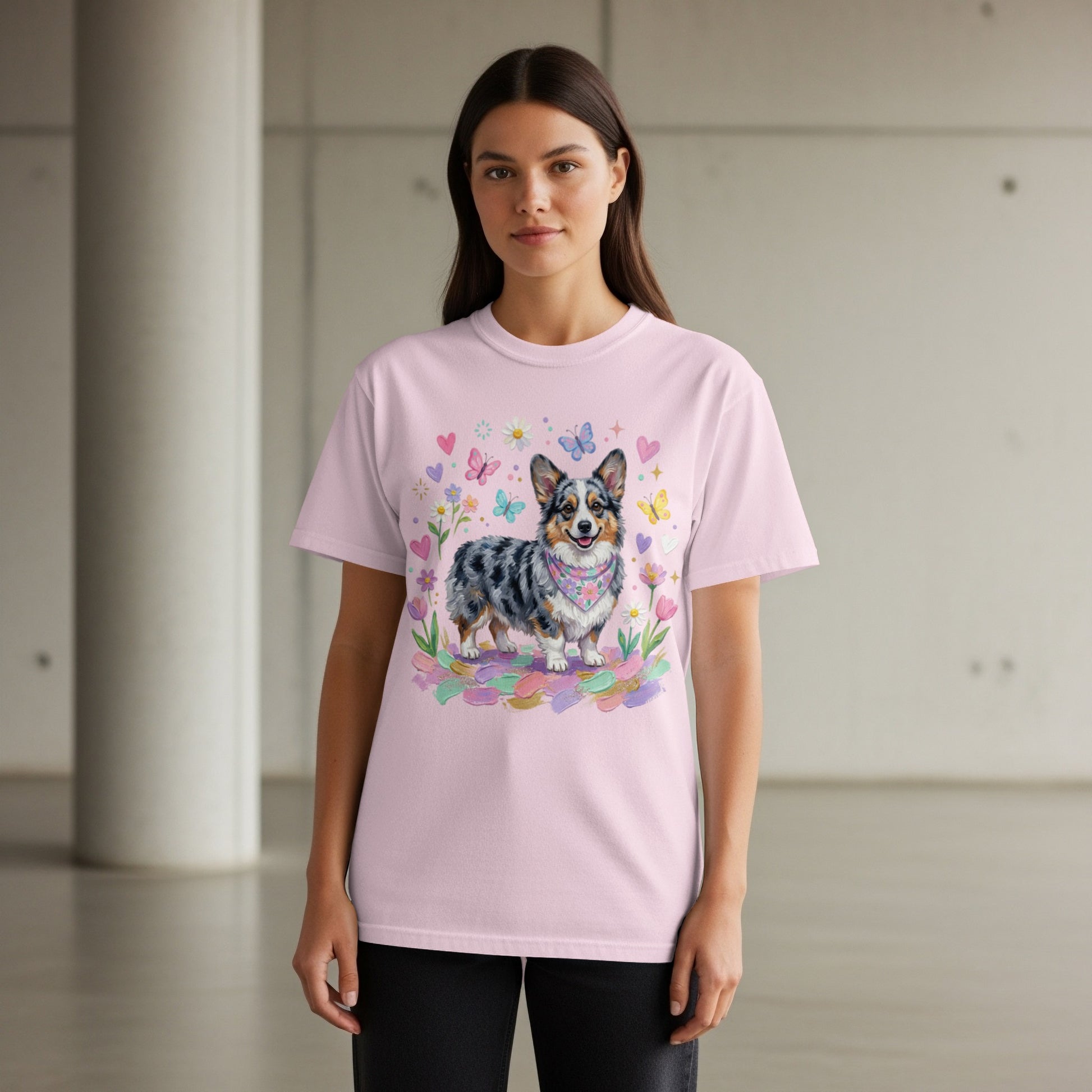 Pink t-shirt featuring a fluffy corgi wearing a bandana with butterflies and flowers.