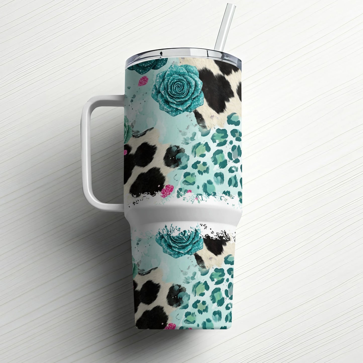 Tumbler with cow print, leopard print, and teal floral designs.
