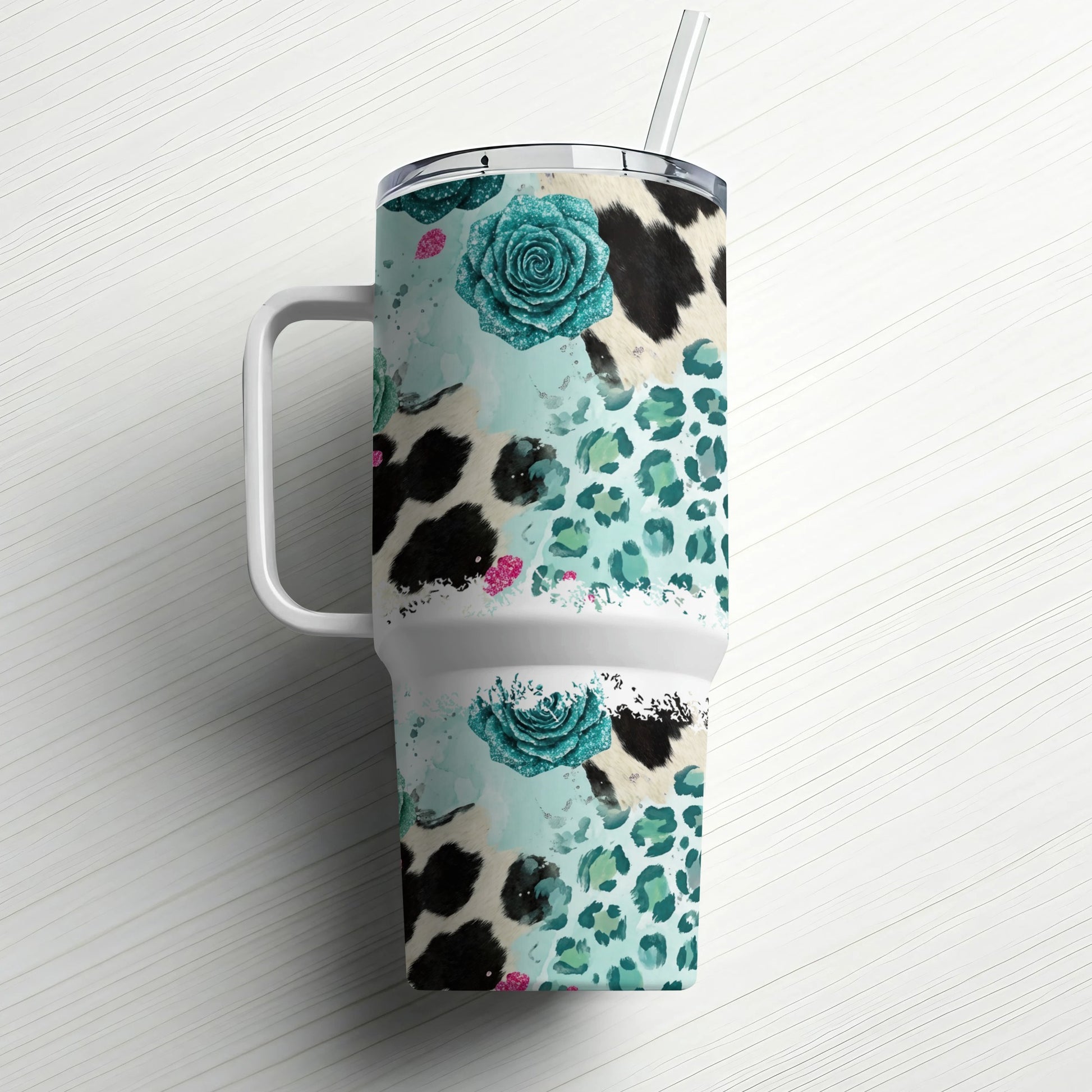 Tumbler with cow print, leopard print, and teal floral designs.