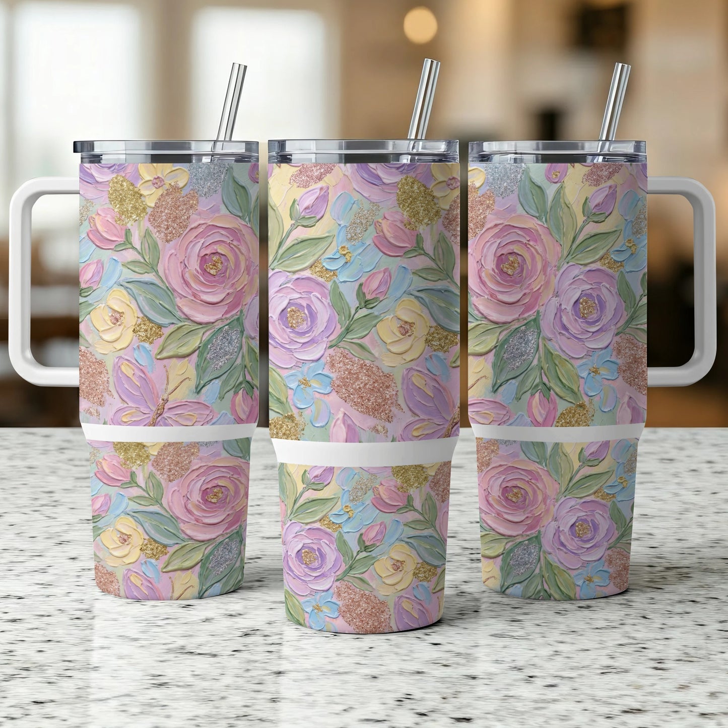 Three tumblers with pastel floral designs and glitter accents.