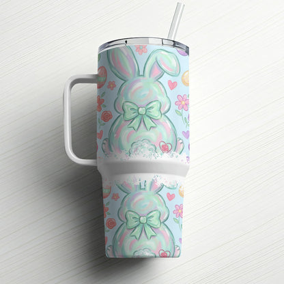 Blue tumbler with pastel Easter bunny pattern and straw.