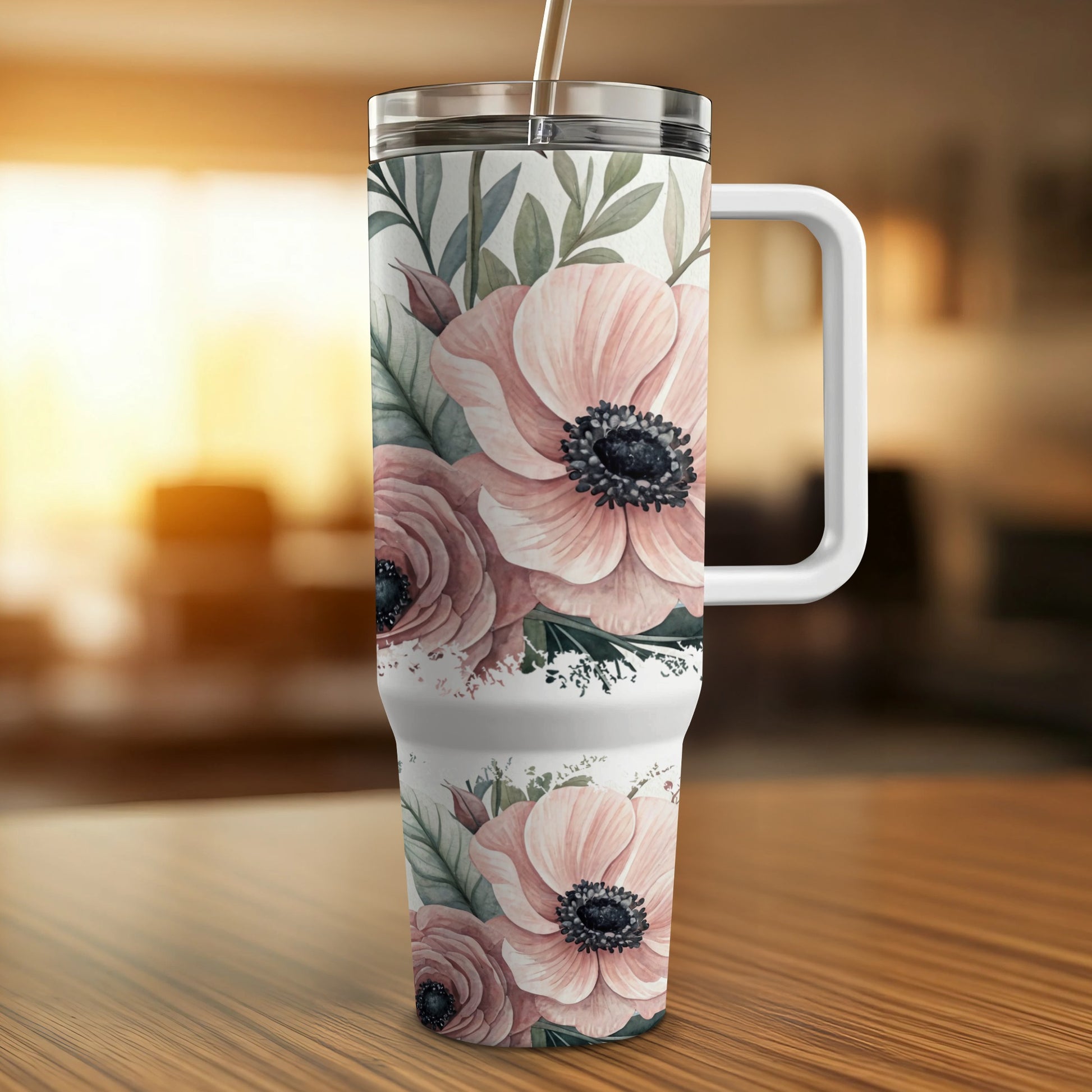 White tumbler with pink floral design and straw.