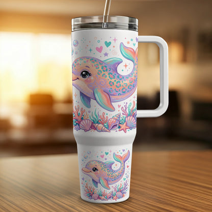 White tumbler with cartoon dolphins, seashells, and hearts, features a handle.
