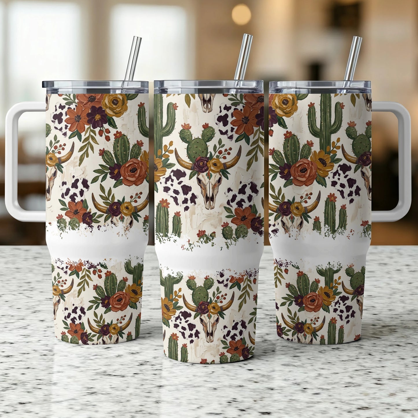 Three identical tumblers with a cow skull and cactus floral design.