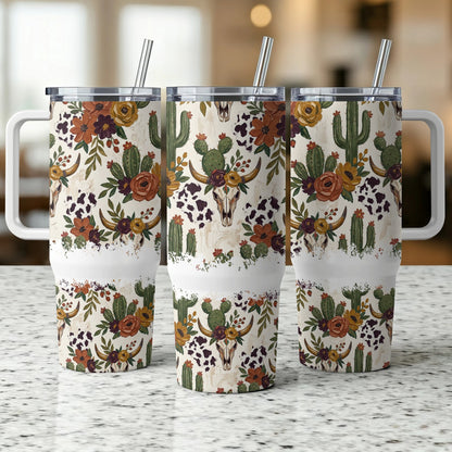 Three identical tumblers with a cow skull and cactus floral design.